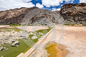 Rests of water and an old dam during dry season near Ai-Ais Hot Springs at Fish River Canyon, Namibia