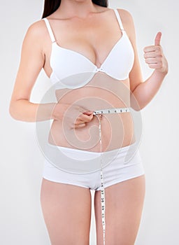 The result I wanted. A young woman measuring her waistline and giving you a thumbs up.