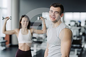 Result take effort. The athlete relaxing in the gym after strength exercises for different muscles, work out his body, push-up,