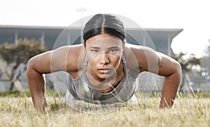 Results happen overtime not over night. Shot of a beautiful young woman doing push-ups outside.