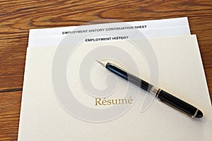 Resume folder with pen and employment history