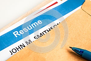 Resume letter background in brown envelop and pen