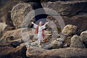 Resurrected Jesus Christ standing in front of the entrance to the grave - tomb.