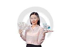 Retail commercial business concept, Asian beautiful woman holding banknote money in hand and shopping cart in another hand