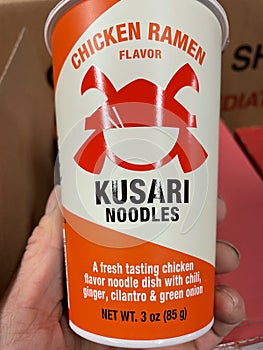 Retail grocery store hand holding Kusari noodles cup