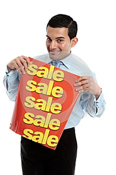 Retail salesman holding a sale sign banner