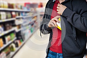 Retail Shoplifting. Man Stealing In Supermarket photo