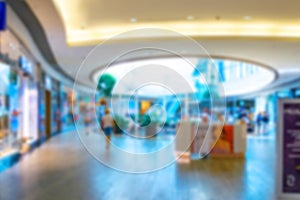 Retail shoppers blurred background. Interior of retail centre store in soft focus. People shopping in modern commercial mall