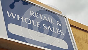 retail and whole sales caption writing text sign on store building in capitals