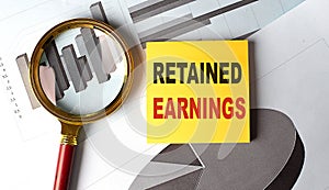 RETAINED EARNINGS text on a sticky on chart, business