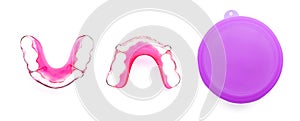 Retainer Pink with Purple Plastic Case Isolated on a White Background with Clipping Path. Closeup of Red Acrylic Dental Removable