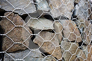 Retaining wall close-up, gabion baskets with stones