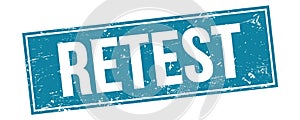 RETEST text on blue grungy rectangle stamp