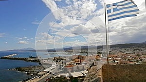 Rethimno / Greece - November 2020: The coast road around the fortress castle in Rethimno Crete. Flag flying