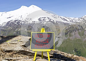 Rethink revise rebrand symbol. Concept word Rethink Revise Rebrand on beautiful blackboard. Beautiful mountain Elbrus background.