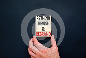 Rethink revise rebrand symbol. Concept word Rethink Revise and Rebrand on beautiful block. Beautiful black background. Business