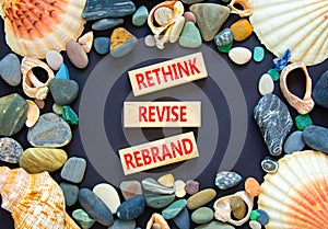 Rethink revise rebrand symbol. Concept word Rethink Revise Rebrand on beautiful block. Beautiful black table black background.