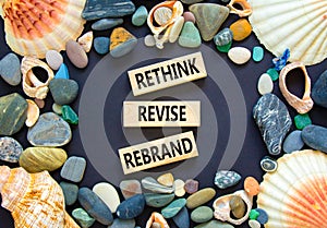 Rethink revise rebrand symbol. Concept word Rethink Revise Rebrand on beautiful block. Beautiful black table black background.