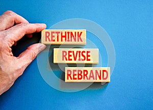 Rethink revise rebrand symbol. Concept word Rethink Revise Rebrand on beautiful block. Beautiful blue table blue background.