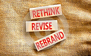 Rethink revise rebrand symbol. Concept word Rethink Revise Rebrand on beautiful block. Beautiful canvas table canvas background.