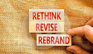 Rethink revise rebrand symbol. Concept word Rethink Revise Rebrand on beautiful block. Beautiful canvas table canvas background.