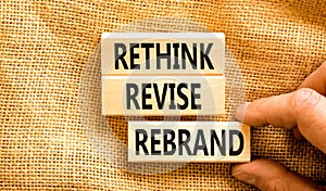 Rethink revise rebrand symbol. Concept word Rethink Revise Rebrand on beautiful block. Beautiful canvas table canvas background.