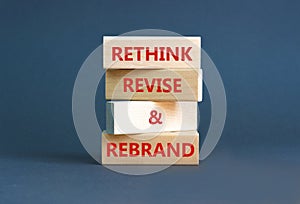 Rethink revise rebrand symbol. Concept word Rethink Revise and Rebrand on beautiful block. Beautiful grey background. Business