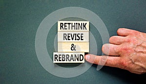 Rethink revise rebrand symbol. Concept word Rethink Revise and Rebrand on beautiful block. Beautiful grey background. Business