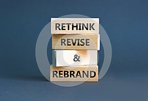 Rethink revise rebrand symbol. Concept word Rethink Revise and Rebrand on beautiful block. Beautiful grey background. Business