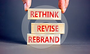 Rethink revise rebrand symbol. Concept word Rethink Revise Rebrand on beautiful block. Beautiful grey table grey background.