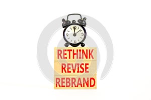 Rethink revise rebrand symbol. Concept word Rethink Revise Rebrand on beautiful block. Beautiful white table white background.