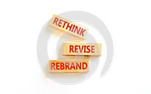 Rethink revise rebrand symbol. Concept word Rethink Revise Rebrand on beautiful block. Beautiful white table white background.