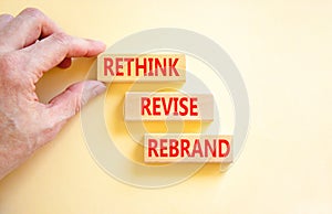 Rethink revise rebrand symbol. Concept word Rethink Revise Rebrand on beautiful block. Beautiful white table white background.