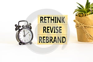 Rethink revise rebrand symbol. Concept word Rethink Revise Rebrand on beautiful block. Beautiful white table white background.