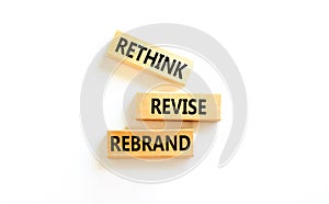 Rethink revise rebrand symbol. Concept word Rethink Revise Rebrand on beautiful block. Beautiful white table white background.