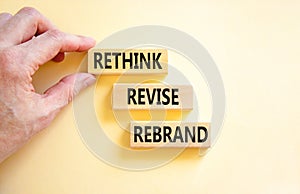Rethink revise rebrand symbol. Concept word Rethink Revise Rebrand on beautiful block. Beautiful white table white background.