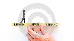 Rethink revise rebrand symbol. Concept word Rethink Revise Rebrand on beautiful block. Beautiful white table white background.