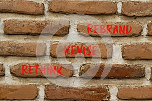 Rethink revise rebrand symbol. Concept word Rethink Revise Rebrand on beautiful bricks. Beautiful red brown brickwall background.