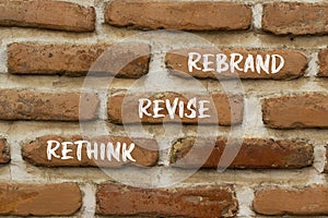Rethink revise rebrand symbol. Concept word Rethink Revise Rebrand on beautiful bricks. Beautiful red brown brickwall background.