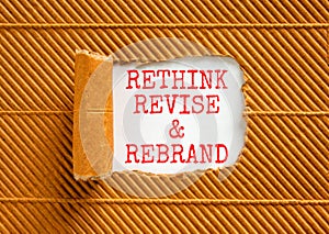 Rethink revise rebrand symbol. Concept word Rethink Revise and Rebrand on beautiful paper. Beautiful brown paper background.