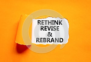 Rethink revise rebrand symbol. Concept word Rethink Revise and Rebrand on beautiful paper. Beautiful orange paper background.
