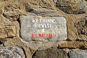 Rethink revise rebrand symbol. Concept word Rethink Revise and Rebrand on beautiful stone. Beautiful stone wall background.