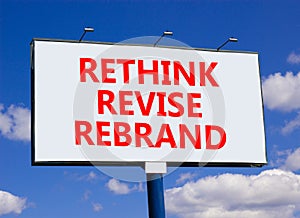 Rethink revise rebrand symbol. Concept word Rethink Revise Rebrand on beautiful white billboard. Beautiful blue sky background.