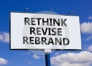 Rethink revise rebrand symbol. Concept word Rethink Revise Rebrand on beautiful white billboard. Beautiful blue sky background.