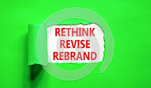 Rethink revise rebrand symbol. Concept word Rethink Revise Rebrand on beautiful white paper. Beautiful green table background.