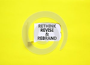 Rethink revise rebrand symbol. Concept word Rethink Revise and Rebrand on beautiful white paper. Beautiful yellow background.