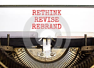 Rethink revise rebrand symbol. Concept word Rethink Revise Rebrand typed on retro typewriter. Beautiful white paper background.