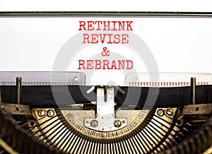 Rethink revise rebrand symbol. Concept word Rethink Revise and Rebrand typed on typewriter. Beautiful white paper background.