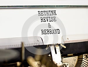 Rethink revise rebrand symbol. Concept word Rethink Revise and Rebrand typed on typewriter. Beautiful white paper background.