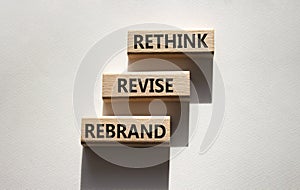 Rethink Revise Rebrand symbol. Wooden blocks with words Rethink Revise Rebrand. Beautiful white background. Business and Rethink